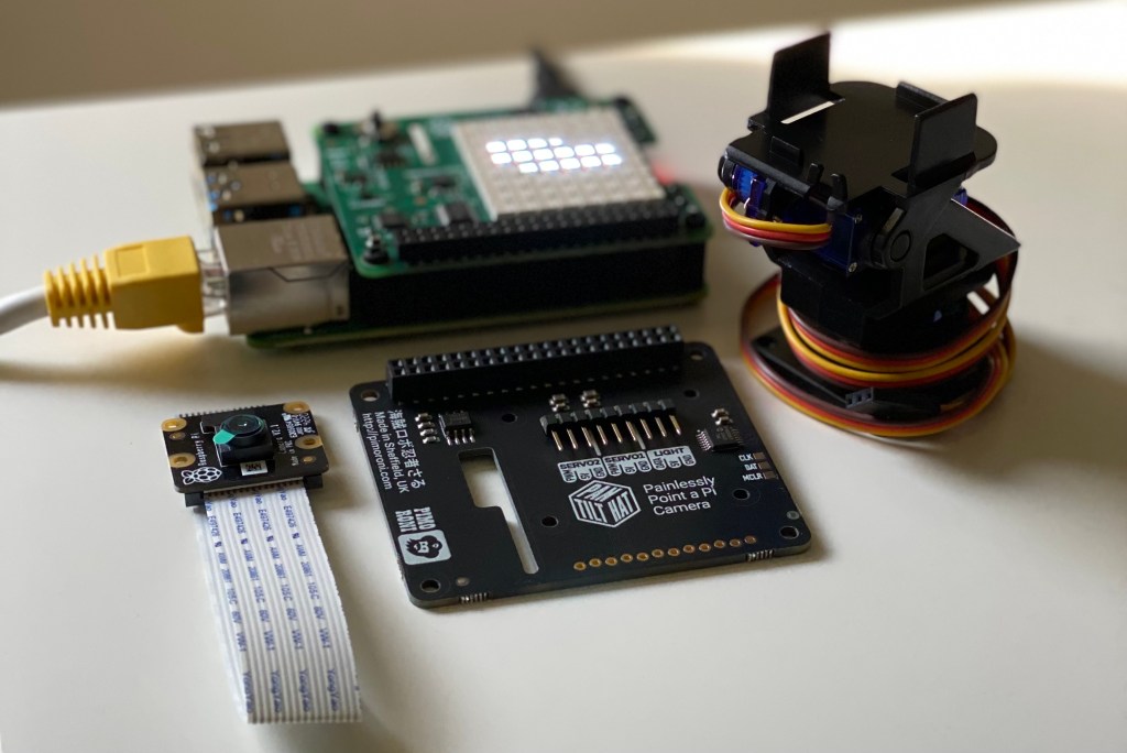 A Raspberry Pi 4 with a disassembled pan-tilt hat and camera.
